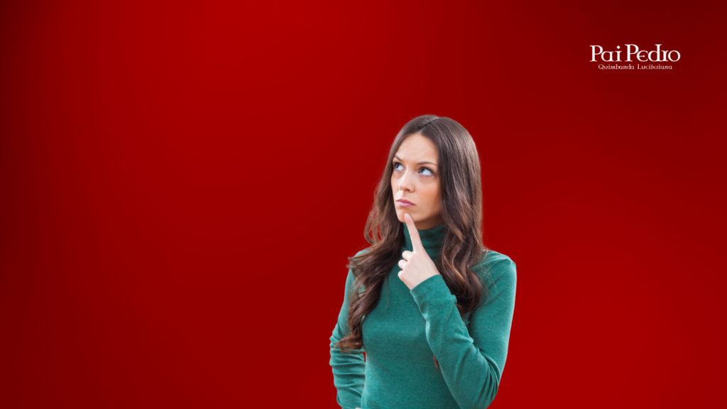 Mulher pensativa em frente a um fundo vermelho, olhando para cima com expressão de dúvida, representando a reflexão sobre como interpretar sonhar com ex namorado e seus significados. 